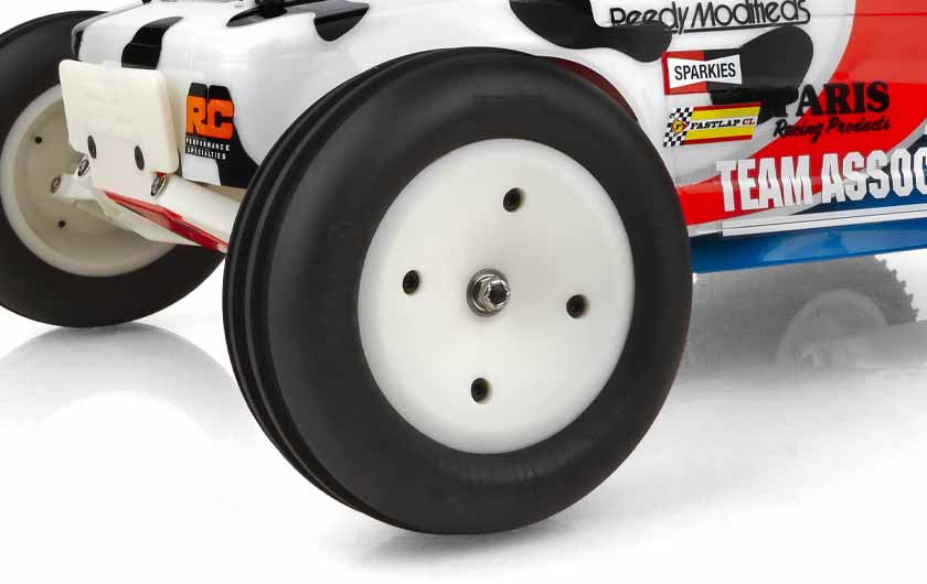 Narrow front tires are pre mounted on white wheels